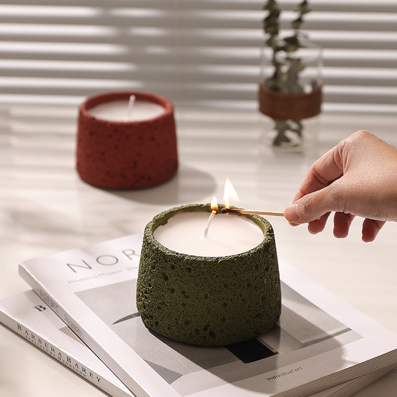 Beige tealight holder with lit tealight